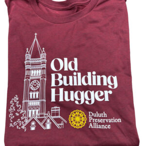 Maroon t-shirt featuring a white line drawing of a clock tower, the text “Old Building Hugger,” and the yellow and white Duluth Preservation Alliance logo.